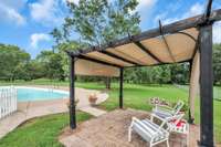 The pergola conveys and adds a nice area to hang out at when you want to get out of the pool but stay in the shade.