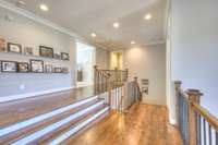 Spacious hallway provides overlook to first floor