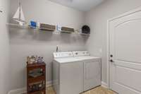 Large laundry room with door that leads to the 2 car garage