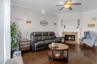 Living room with FP & gas logs & beautiful hardwood floors.