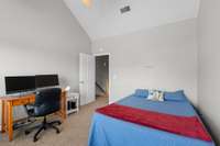 Guest bedroom w/ extra-large walk-in closet & cathedral ceiling.
