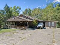 House on property has a 2 bedroom septic system in place as well as water and electricity- needs extensive renovations or to be torn down