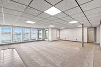 Look at this massive lower level play / Bonus room, Media Center, Man Cave or more overlooking the Lake