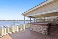 View of the deck & jacuzzi overlooking the lake