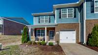 Well manicured landscaping, front porch with seating, and end unit for extra natural light. This townhome has it all!