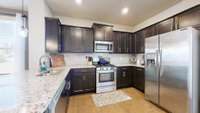 Beautiful kitchen with granite countertops, gas oven/stove and large refrigerator. All kitchen appliances convey.