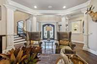 Living area looking back toward foyer and front door. Check the woodwork
