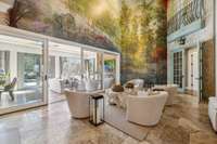 Soaring ceilings in the "mural room" invite you to the patio room