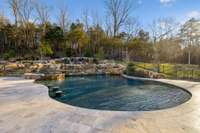 excuisite free form pool with hot tub, waterfalls, fire area and outdoor grill.