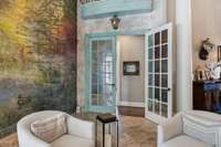 French doors lead to primary suite on main level