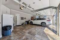 Tiled floor in upper three car garage with separate closet