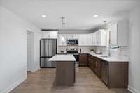 This kitchen is gorgeous with its two-toned cabinets and quartz counters!