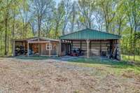 Carports for vehicles, machinery, extra toys, space for hobbies or pets.  The carport will cover three vehicles. This carport also has enclosed space that could be used as an office or for storage space.
