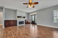 Spacious living room with stone fireplace and custom-built entertainment center.