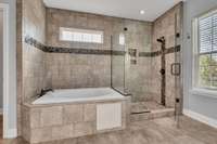 Spacious walk-in shower and garden tub features gorgeous tile. Enjoy a Spa Day at home in this beautiful garden tub.