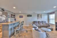 Huge media room or den has a nice bar area