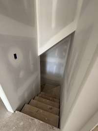 entrance to the basement off garage pedestrian door