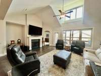 Vaulted ceiling in Living Room with hardwood flooring with gas fireplace with mantle overlooking the screened backporch. 3 Bedrooms 3 full baths with large unfinished flex room over the 2 car garage