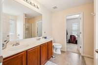 Primary bathroom with double sink vanity.  Bathroom has separate shower and garden tub