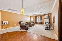 Cozy den with wood burning fireplace.  Fireplace has never been used.  Owner preferred electric insert