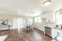 The kitchen has easy access to all of the living spaces.