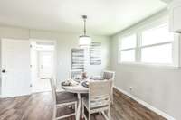 The kitchen nook is located between the kitchen and both living areas for added convenience.