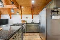 Gas range, granite counter tops and gourmet coziness.