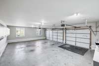 Full sized 3 car garage, finished with wall cabinets and work shop table that can be moved around