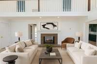 Virtually Staged living room with doublesidedd fireplace to entryway