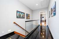 Access to the vast lower level is conveniently located just off the living room, or continue through the hallway to discover the gracefully renovated primary suite, a true upscale retreat.