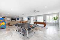 Soaked in natural light, the central downstairs area smoothly flows to the vast outdoor patio. After enjoying the fresh air, guests can easily retreat indoors for further entertainment and relaxation.