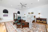 Newly installed hickory hardwood flooring provides a magnificent base for the expansive primary suite, complementing its grandeur.