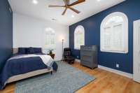 This charming 12ft x 16ft main-level secondary bedroom enjoys serene backyard views framed by three lovely windows, filling the space with natural light and a sense of calm.