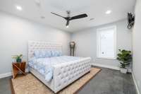 This cozy and carpeted 13ft x 16ft downstairs bedroom has its own door to the neighboring full bathroom.