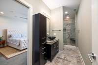 Enhanced with sleek storage, stunning tilework, and a new toilet, this downstairs bathroom exudes effortless style.