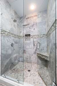 A shower bench, niche, and extra large dimensions promise a luxurious shower experience.