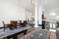 Welcome inside! The soaring ceilings, rows of recessed lighting, and bright, airy interior evoke a truly grand entrance.