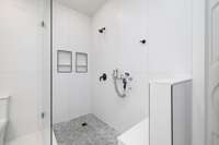 A charming dog spa attachment in this shower makes the hassle of cleaning your furry friends a breeze!