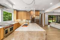 Open-concept design connects the kitchen to the living room and backyard for seamless indoor-outdoor living.