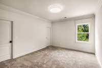 Each bedroom is detailed with crown molding and large windows for natural light.