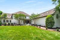 Green spaces abound here with mature trees that border the property, ensuring privacy.