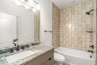 Each bathroom features elegant finishes and consistency in material choices.