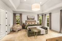 The primary suite on the main level is spacious and bright.
