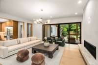 This spacious living room is complete with fireplace, modern lighting, and unobstructed sight lines to the gourmet kitchen.
