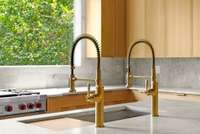 A detailed look at the sleek and modern brass fixtures over the island’s deep sink.