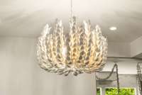 A closer look at the show-stopping light fixture, resembling modern art in motion above the dining table.