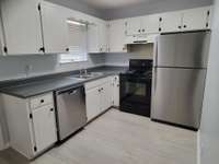Kitchen complete with dishwasher, stove, and refrigerator