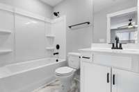 Attached bathroom features tile floors & upgraded fixtures.