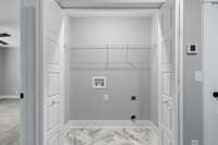 Laundry room is conveniently located upstairs between the bedrooms & includes gorgeous tile flooring.