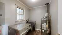 Laundry Room with spacious built in storage area behind door.